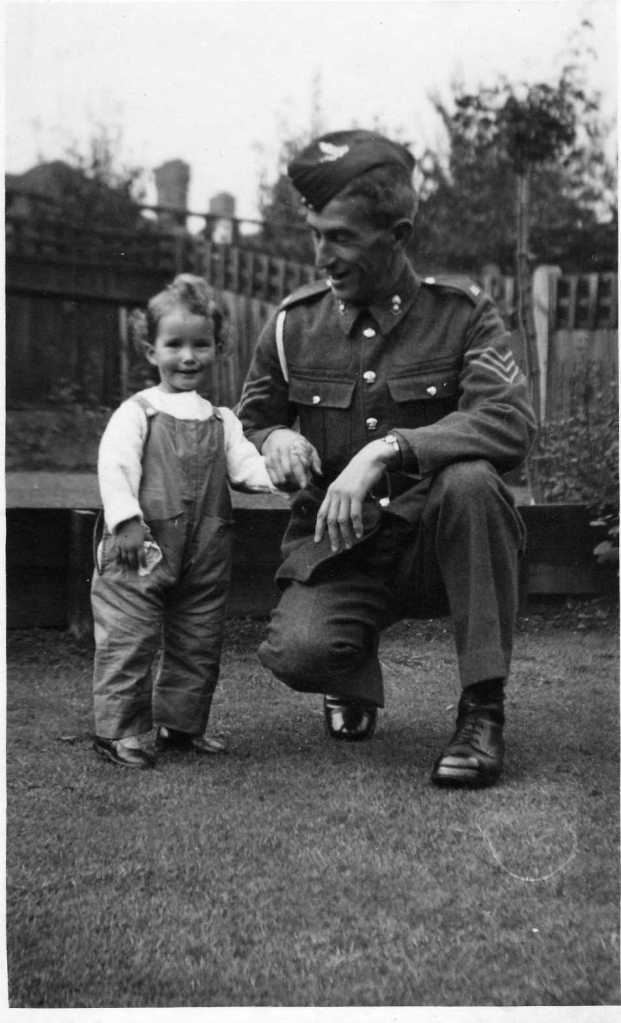 Natalie as a small child with her father in uniform